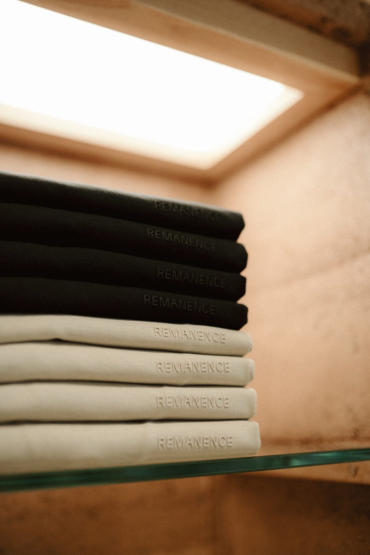 Folded garments under the shelf light