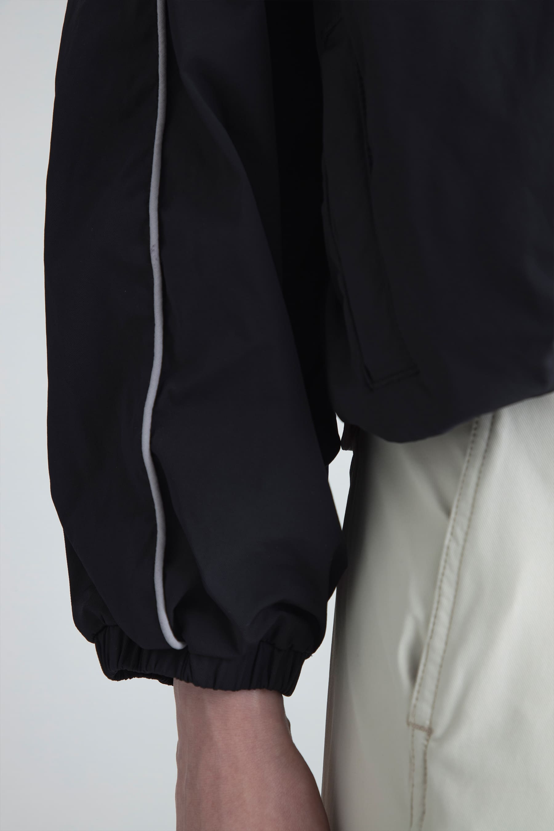 Detail of elastic cuffs with contrast trim