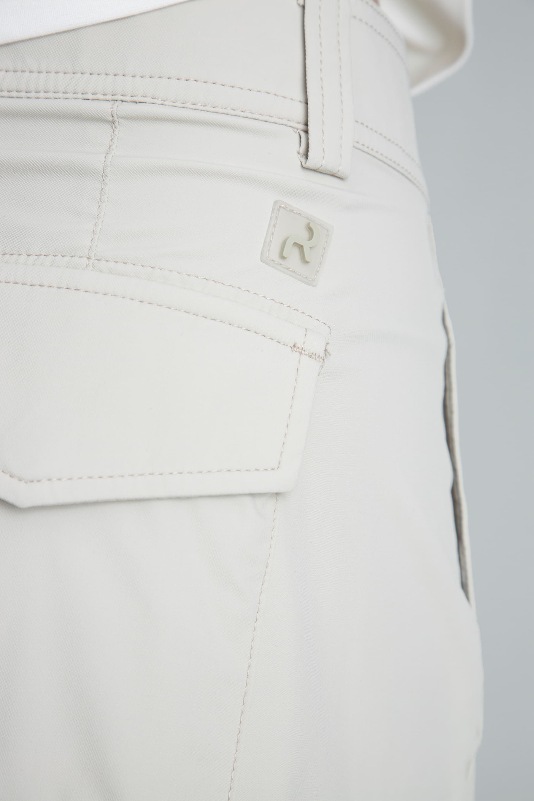 Back pocket detail and subtle logo of the Women's sand straight-leg pants