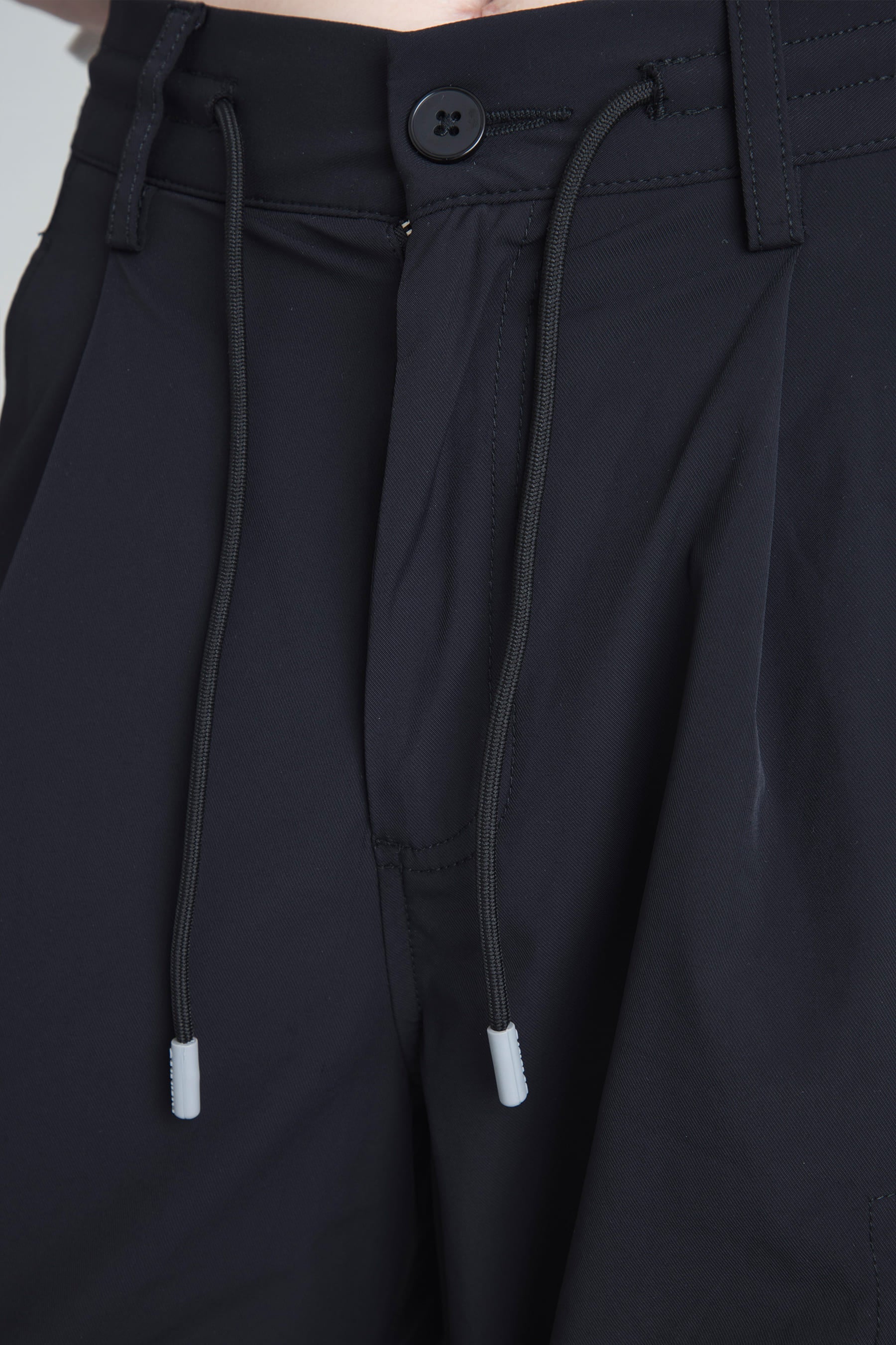 Waistband detail with drawcord on Women's black parachute pants