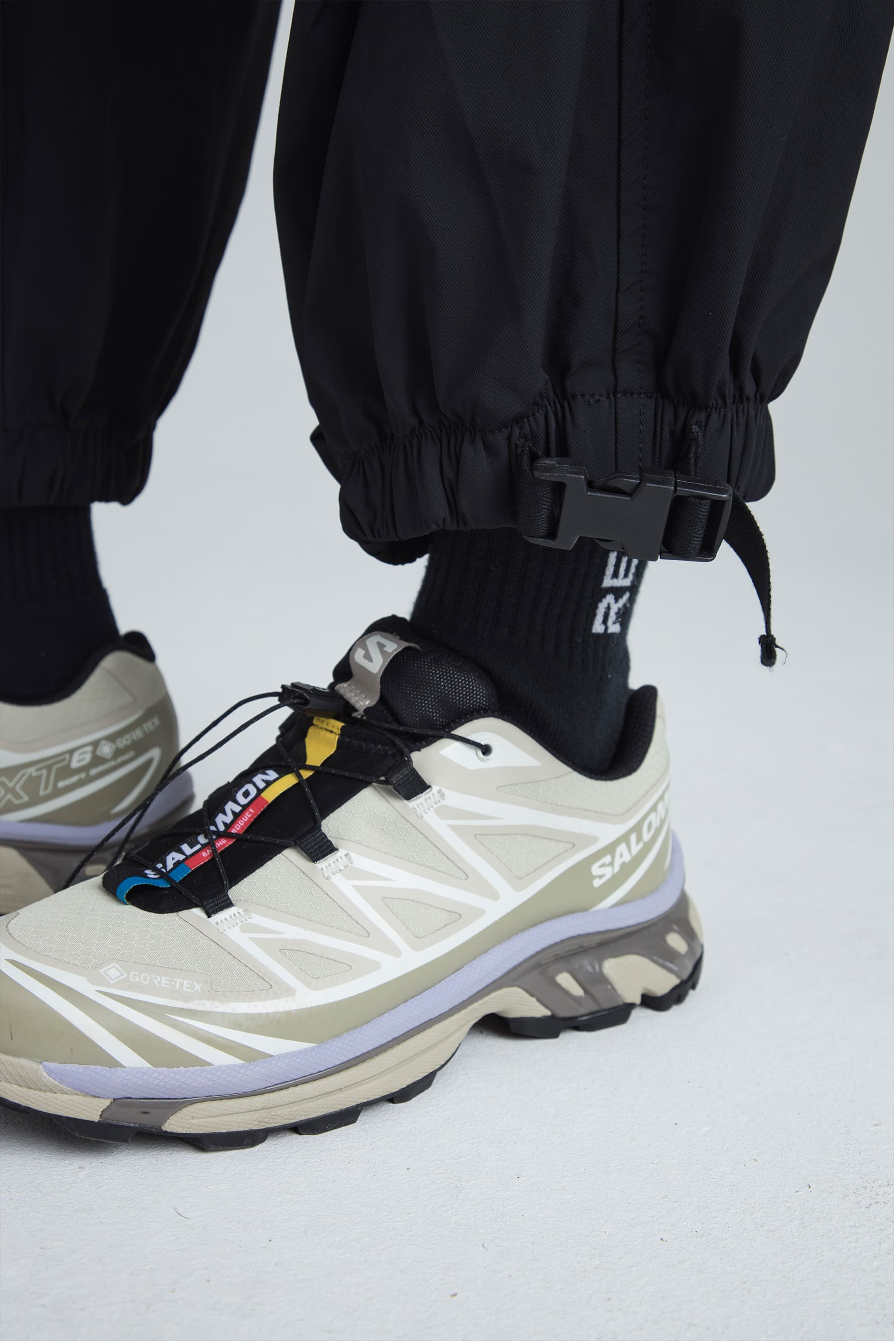 Fit detail at the leg opening on Women's black parachute pants