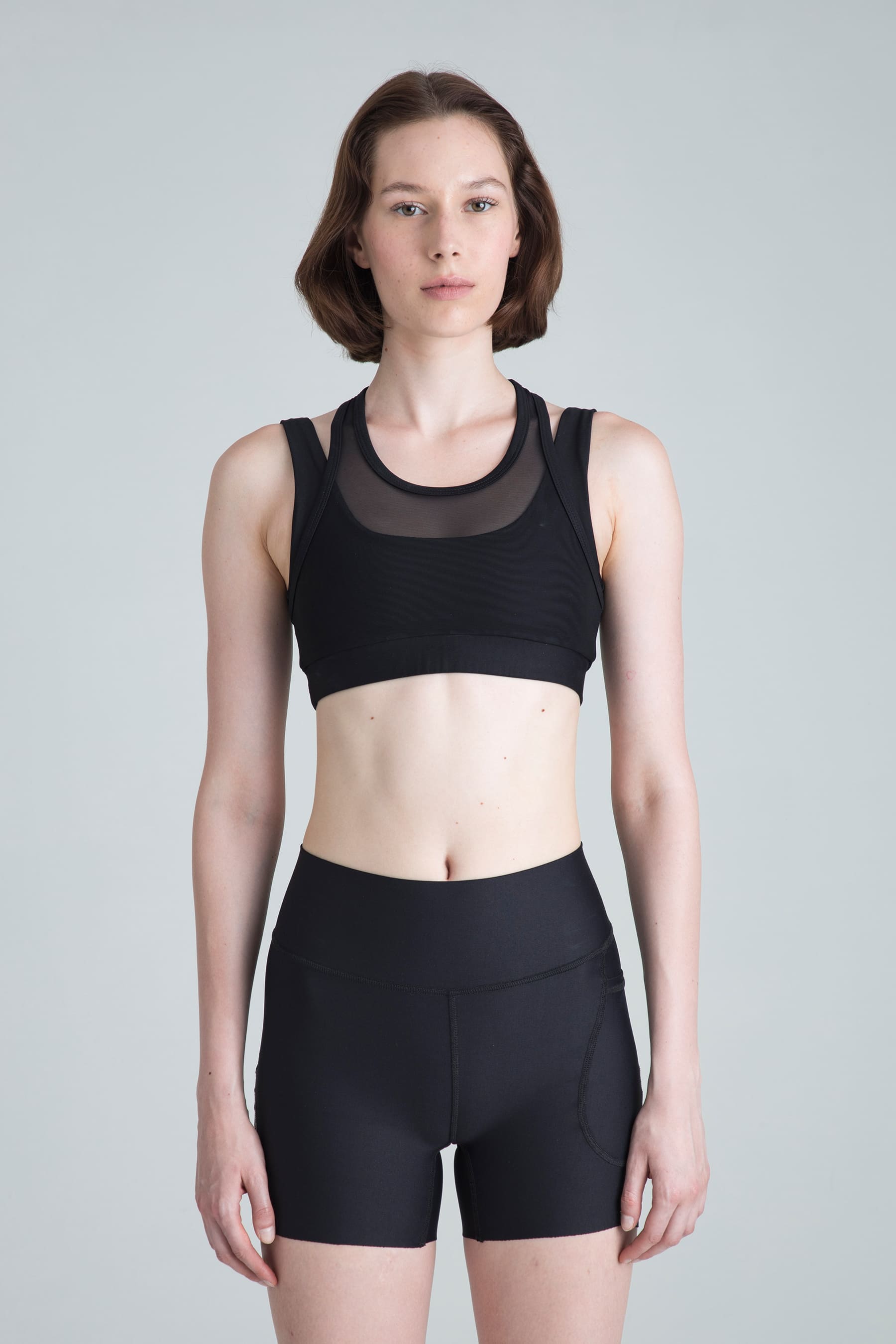 Women's black sports top Apex medium support on model
