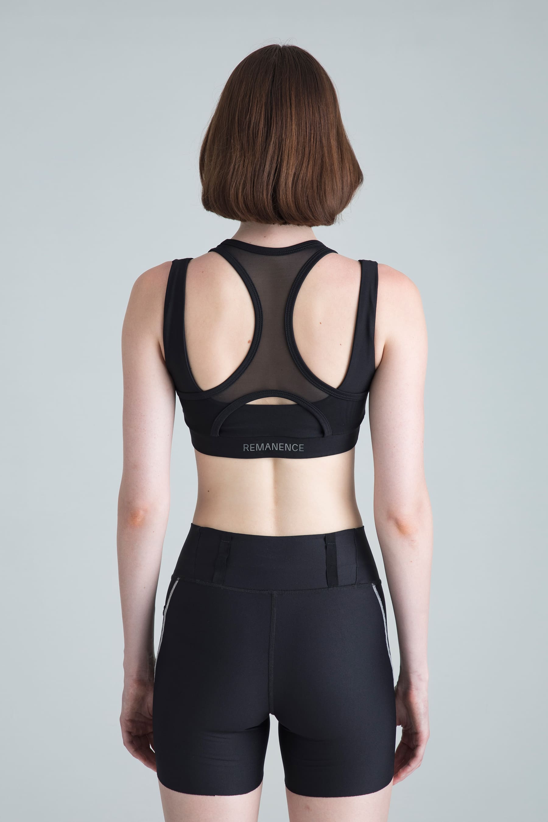 Women's black sports top Apex back view on model