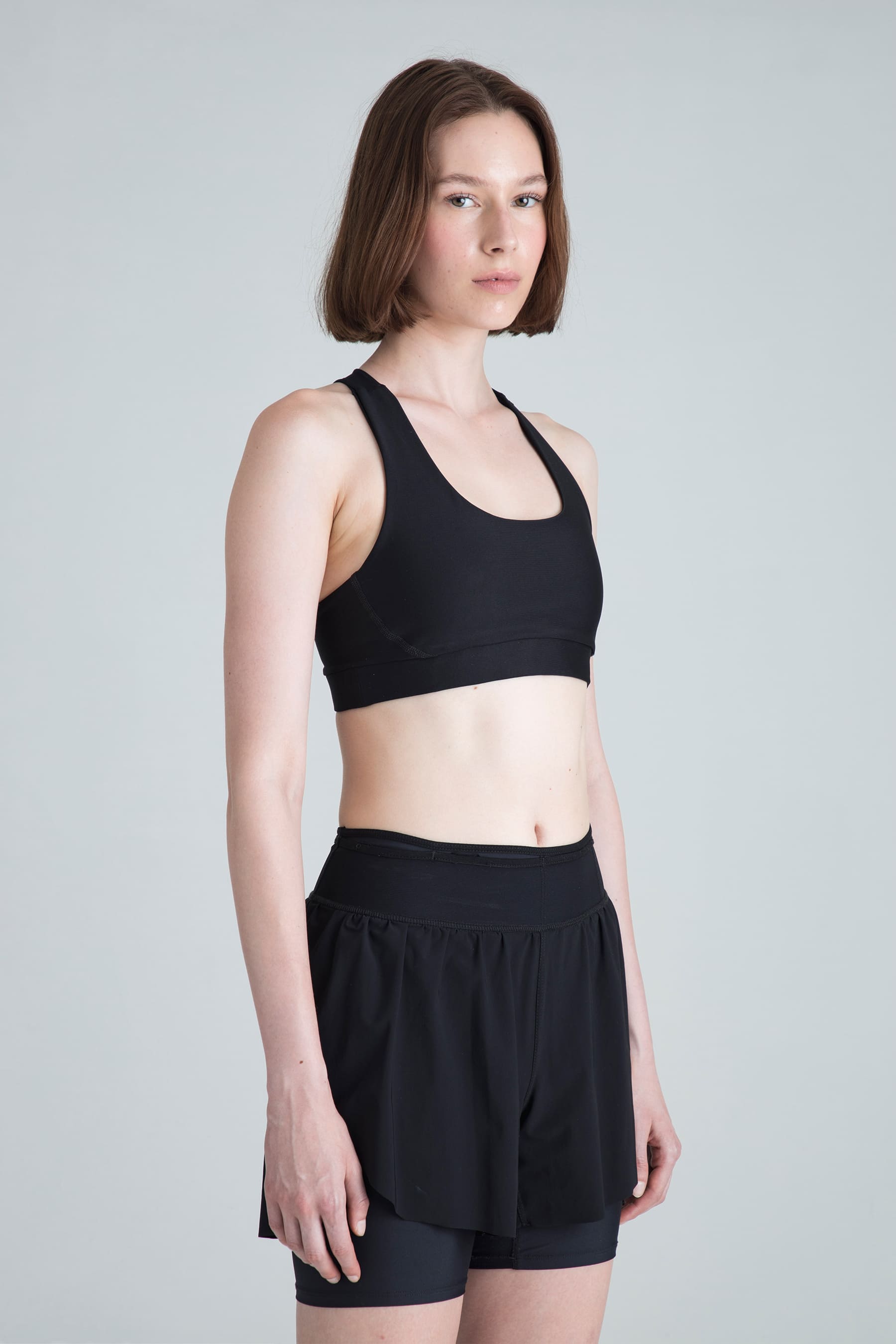 Women's black sports top Motion side profile on model
