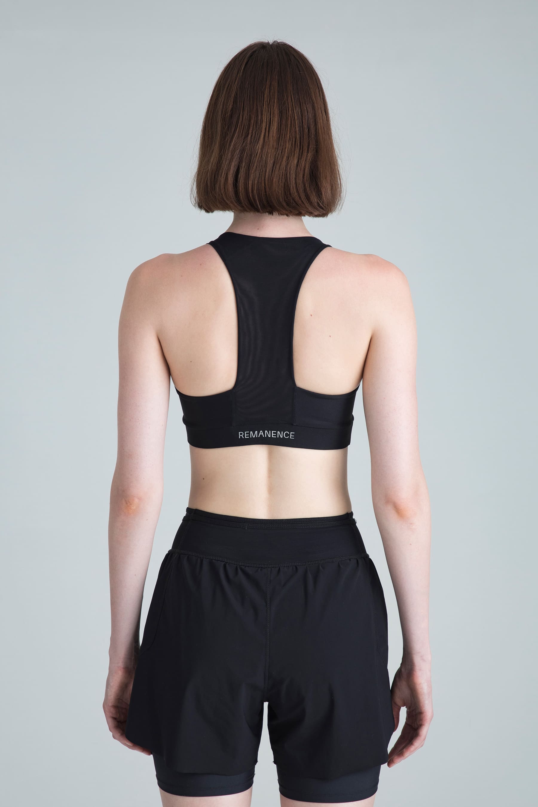 Women's black sports top Motion back view with mesh